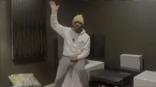 The speaker gesturing upwards, indicating that voices and other audio elements were coming from the ceiling-mounted Atmos speakers.