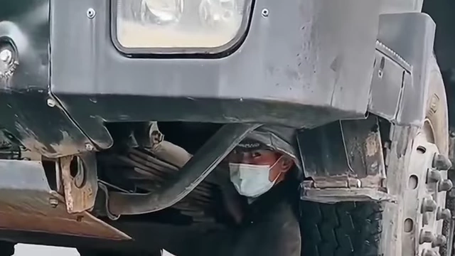 Xiao Ai working on a truck, illustrating one of his diversified income streams through car parts sales