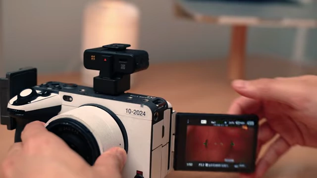 A DJI Mic 3 receiver attached to the hot shoe of a Sony camera, showing the integrated audio setup.