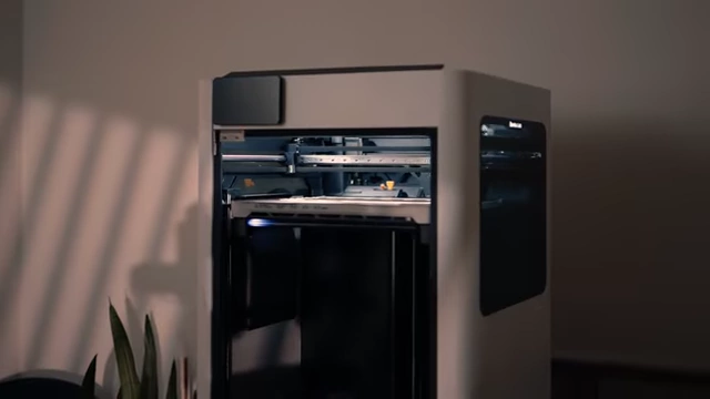 A Bambu Lab H2D 3D printer in action, highlighting its enclosed design.