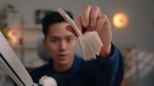 A person holding a fan-like radius gauge, demonstrating how it can be used to measure curves on objects.