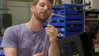 Linus holds up a perfectly bent hardline tube