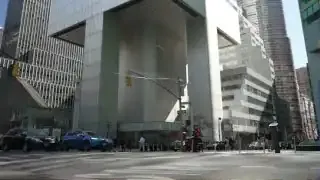Citicorp Center's unique design features its main structure elevated on four central stilts, with Saint Peter's Church nestled beneath one of its corners.