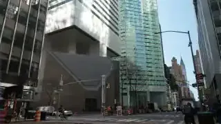 Citicorp Center's unique design features its main structure elevated on four central stilts, with Saint Peter's Church nestled beneath one of its corners.