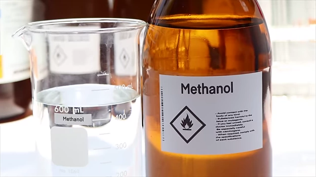 A bottle labeled "Methanol," representing a toxic alcohol that can cause blindness.
