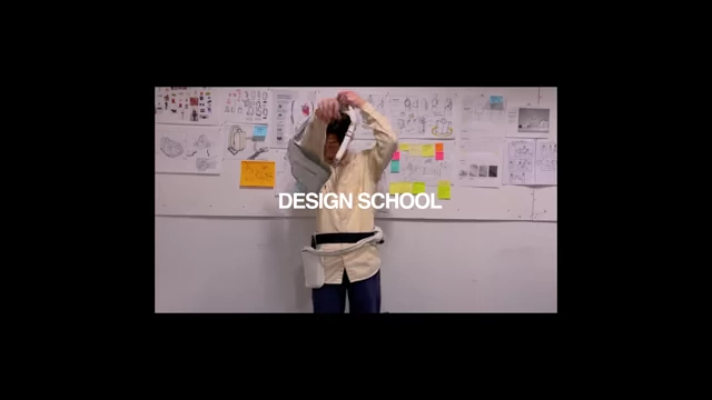 The speaker in a design school setting, demonstrating early design projects