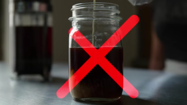 An image of a coffee mug with a red 'X' over it, symbolizing the elimination of liquid calories like cream in coffee.