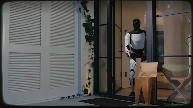Ein humanoider Roboter namens Optimus liefert ein Paket und zeigt die Anwendung von Humanoiden im Alltag.