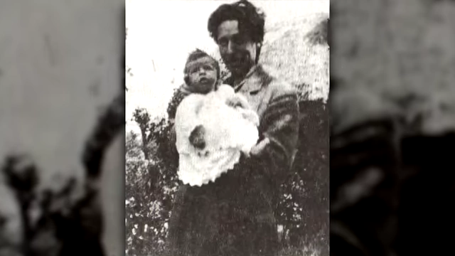 A vintage family photo shows Victor Neuburg as a baby in the arms of a parent