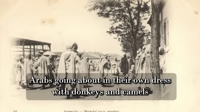 A vintage postcard of an Algerian market with a quote from Neuburg's biography describes the foreign sights as "emotional for him"