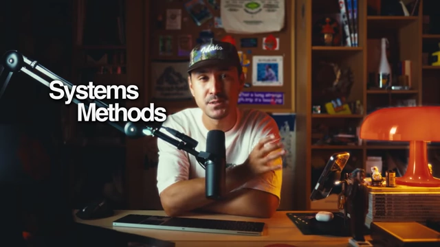 The speaker explaining the use of "Systems Methods" in content creation.