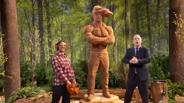 Artist Michael Jones stands with John Oliver and his chainsaw carving of the 'Cabbage Hunk'