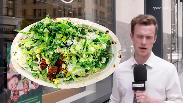 A close-up of a "slop bowl" filled with greens, grains, and various toppings.