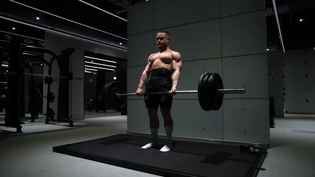 Jeff Nippard performing deadlifts on the dedicated deadlift platform in the light gym.