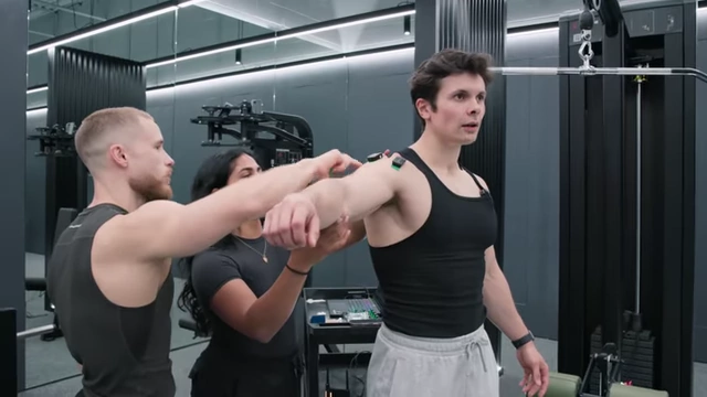 Will Tennyson having EMG electrodes applied to his front, side, and rear deltoids for muscle activation testing.