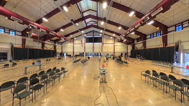 A wide panoramic shot of the empty LANFest venue before the event, showing its large, open layout.