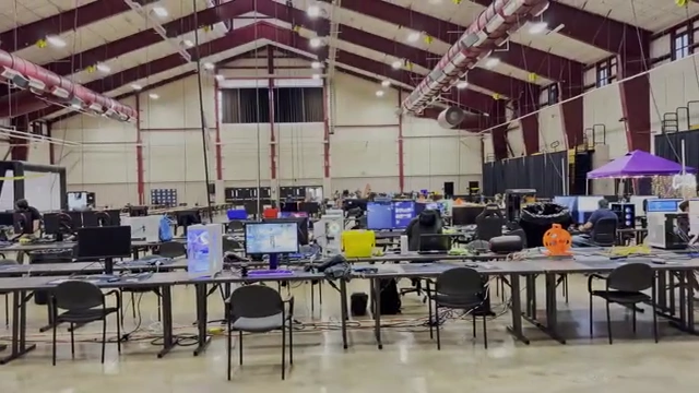 A panoramic view of the LANFest venue with gamers, taken from 200 feet away from the AP, providing context for the long-range speed test.