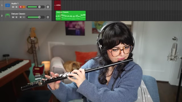 Gabi Belle playing flute to create a track