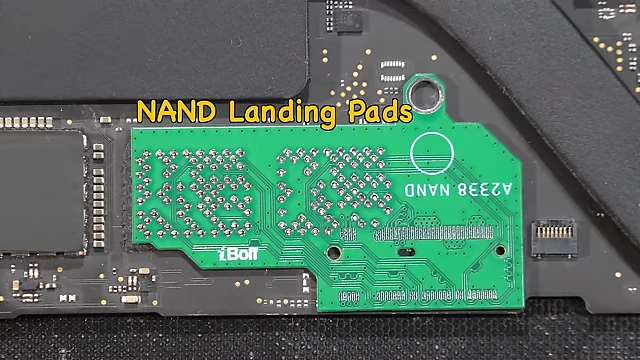 Base adapter PCB with M.2 connector soldered onto the MacBook logic board, showing the initial modification