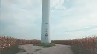 A wind turbine towering over a field, representing a source of infrasound.