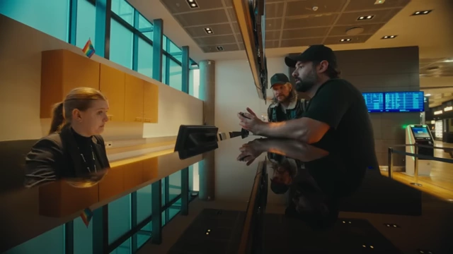 Matti Haapoja and a team member speaking with an airline representative about a cancelled flight