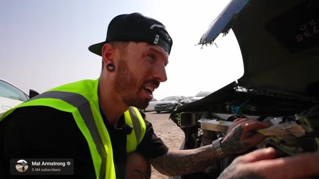 YouTuber Mat Armstrong inspecting a severely damaged car, illustrating how conflict can create engaging content