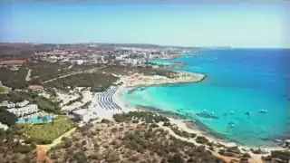 A pristine beach and resort area in Cyprus, offering a more subdued lifestyle