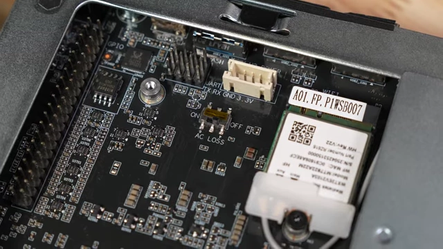 A close-up of the motherboard showing a physical toggle switch labeled "AC LOSS ON / OFF"