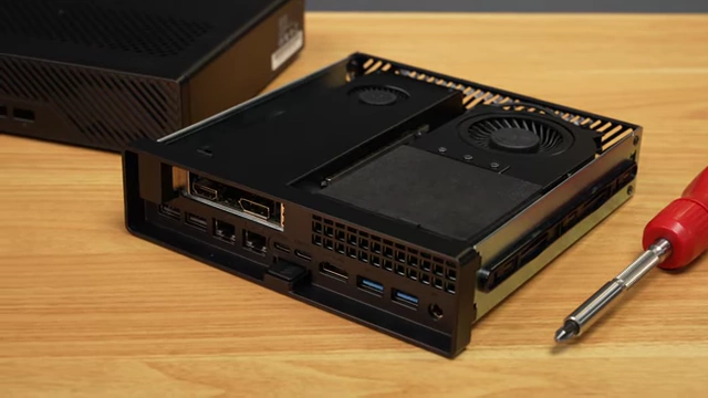The Minisforum MS-R1 with its chassis partly slid open, revealing the internal components and PCIe slot