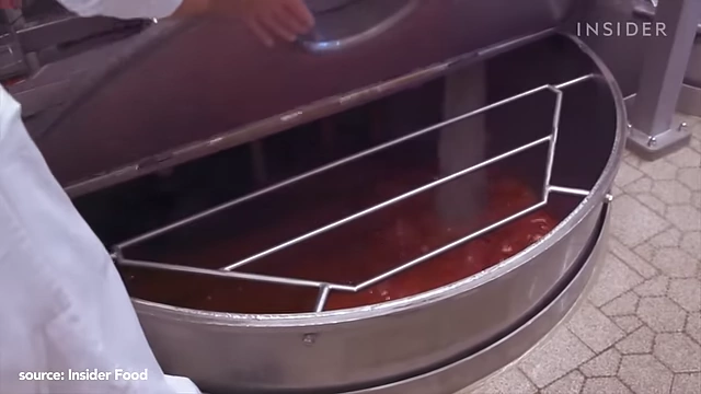 A large industrial vat mixing ingredients for ketchup production.