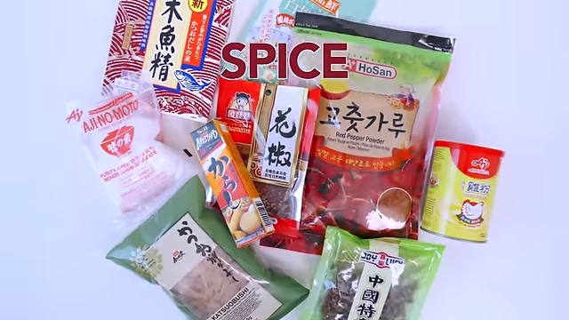 Text overlay "SPICE" on a background of various spice packets and jars.