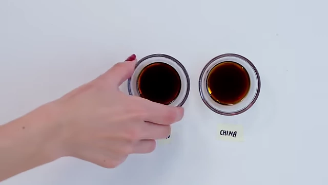 Two small bowls of soy sauce, labeled "Japan" and "China", showing the subtle color variations between regional soy sauces.