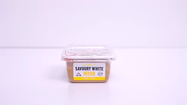 A container of savory white miso.