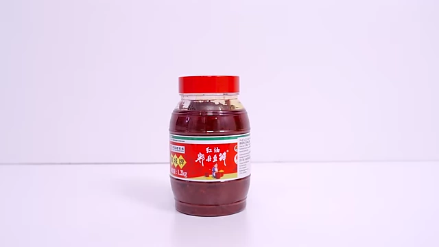 A large jar of Pixian Doubanjiang, a red fermented chili bean paste from Sichuan.