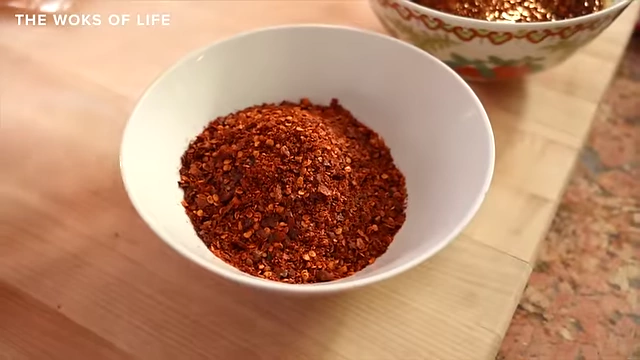 A bowl of chili flakes ready for hot oil to be poured over them to make chili oil.