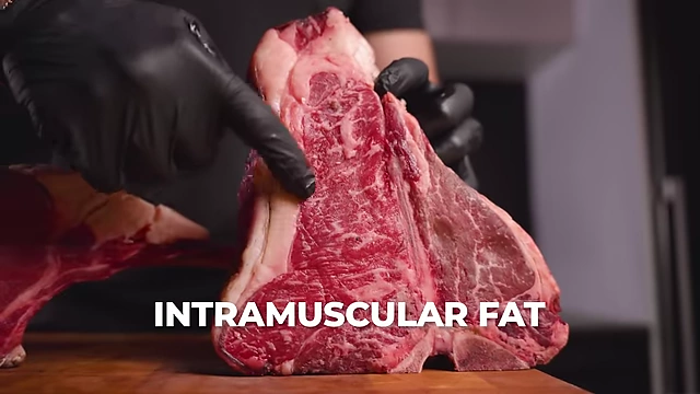 A close-up of a marbled steak, with "INTRAMUSCULAR FAT" pointing to the marbling within the meat.