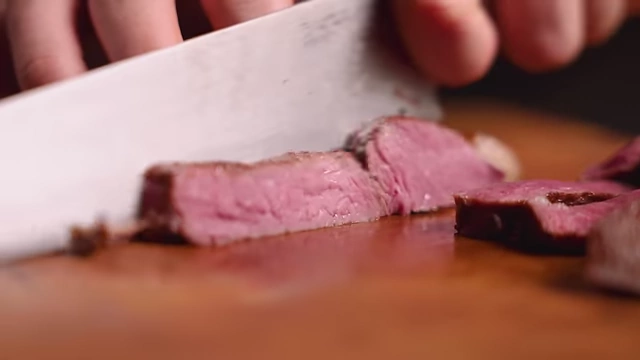 Slices of cooked top sirloin steak, displaying a consistent medium-rare doneness.