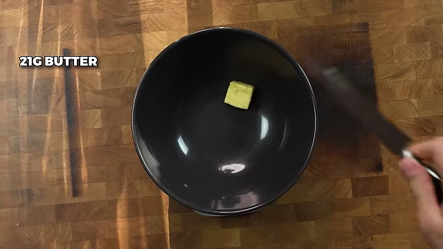 Adding 21g of butter to the wet ingredients for the cookie dough.