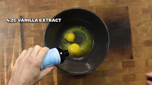 Adding one whole egg, one egg yolk, and 4.2g of vanilla extract.