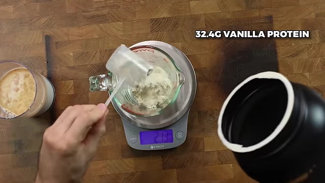 Adding 32.4g of vanilla protein powder to the ice cream base.