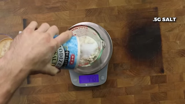 Adding 0.5g of salt to the dry ingredients.