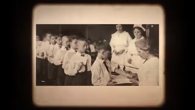 Historical photo showing children lining up to receive vaccinations.