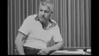 A participant in the Milgram experiment, showing visible distress while following commands from an authority figure.