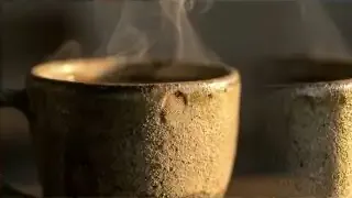 Steaming ceramic cup on a minimalist table, representing a quiet moment of intention and the subtle warmth of K-culture.