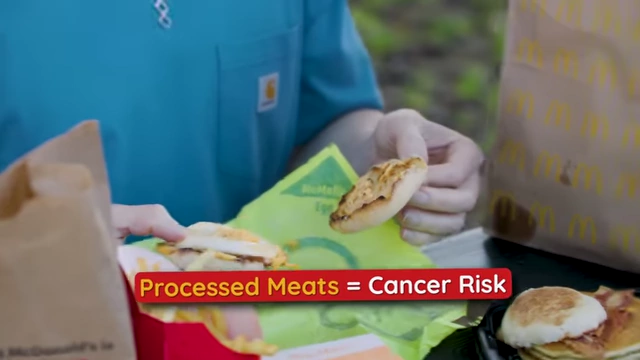 A text graphic stating "Processed Meats = Cancer Risk" displayed next to an unwrapped Egg McMuffin.