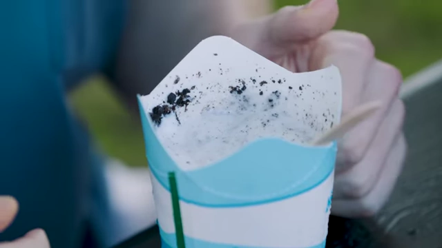 A close-up of a McFlurry with Oreos, showing the cookie pieces mixed into the ice cream.