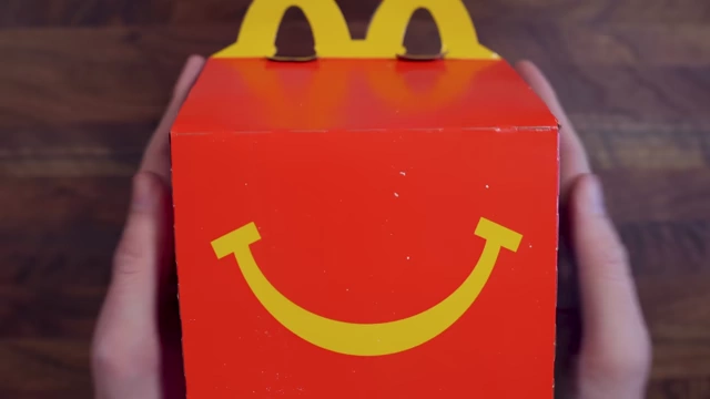A McDonald's Happy Meal box with a smiling face.