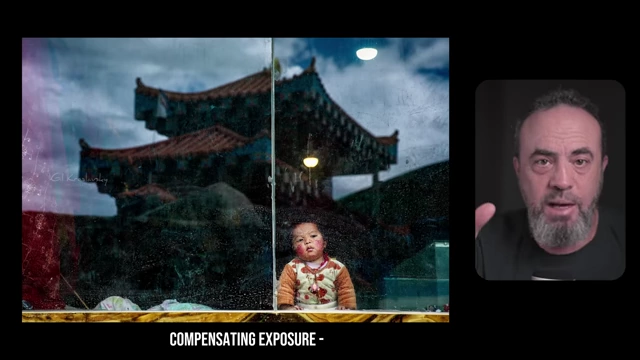 Decreasing exposure compensation for a naturally dark scene