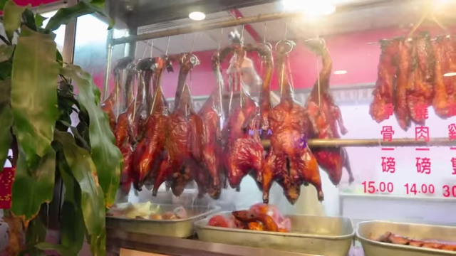Roasted ducks and pork hanging in a Chinatown restaurant window