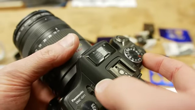 A camera with a finely etched microphone grille, serving as an example of intricate metal components in electronics.